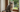 cat sits beside window